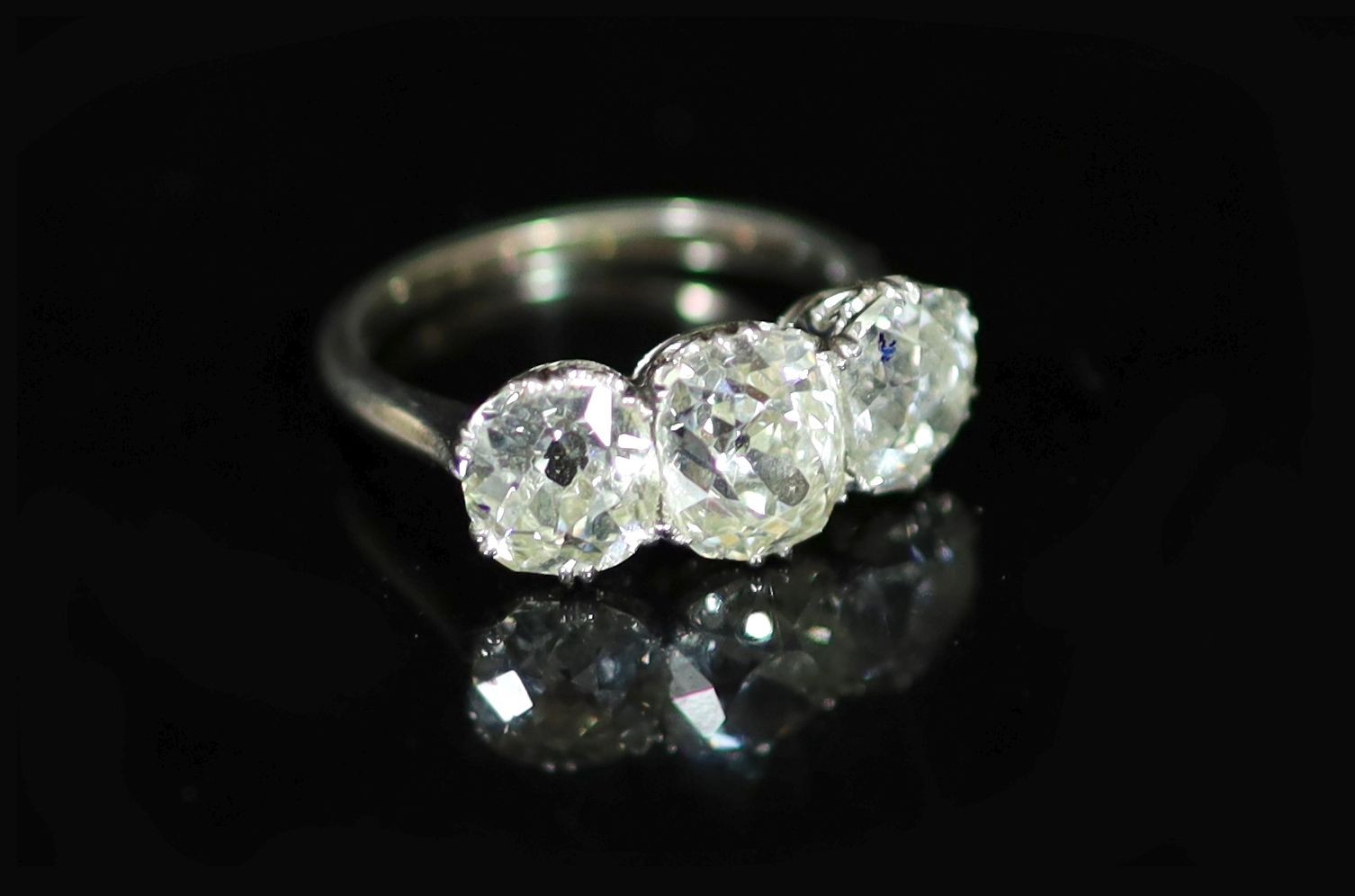 A platinum? and three stone diamond ring
